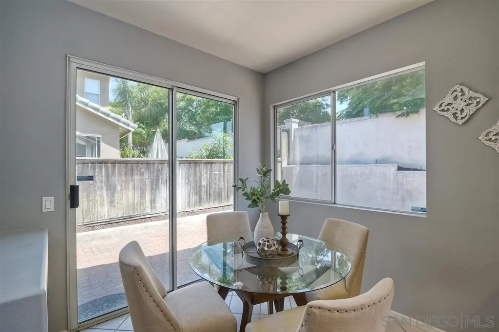 11574 Village Ridge Road San Diego, CA 92131 - Photo 9 of 25 a dining room with furniture wooden floor and a potted plant