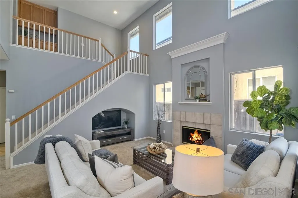 11574 Village Ridge Road San Diego, CA 92131 - Photo 10 of 25 a living room with furniture and a fireplace