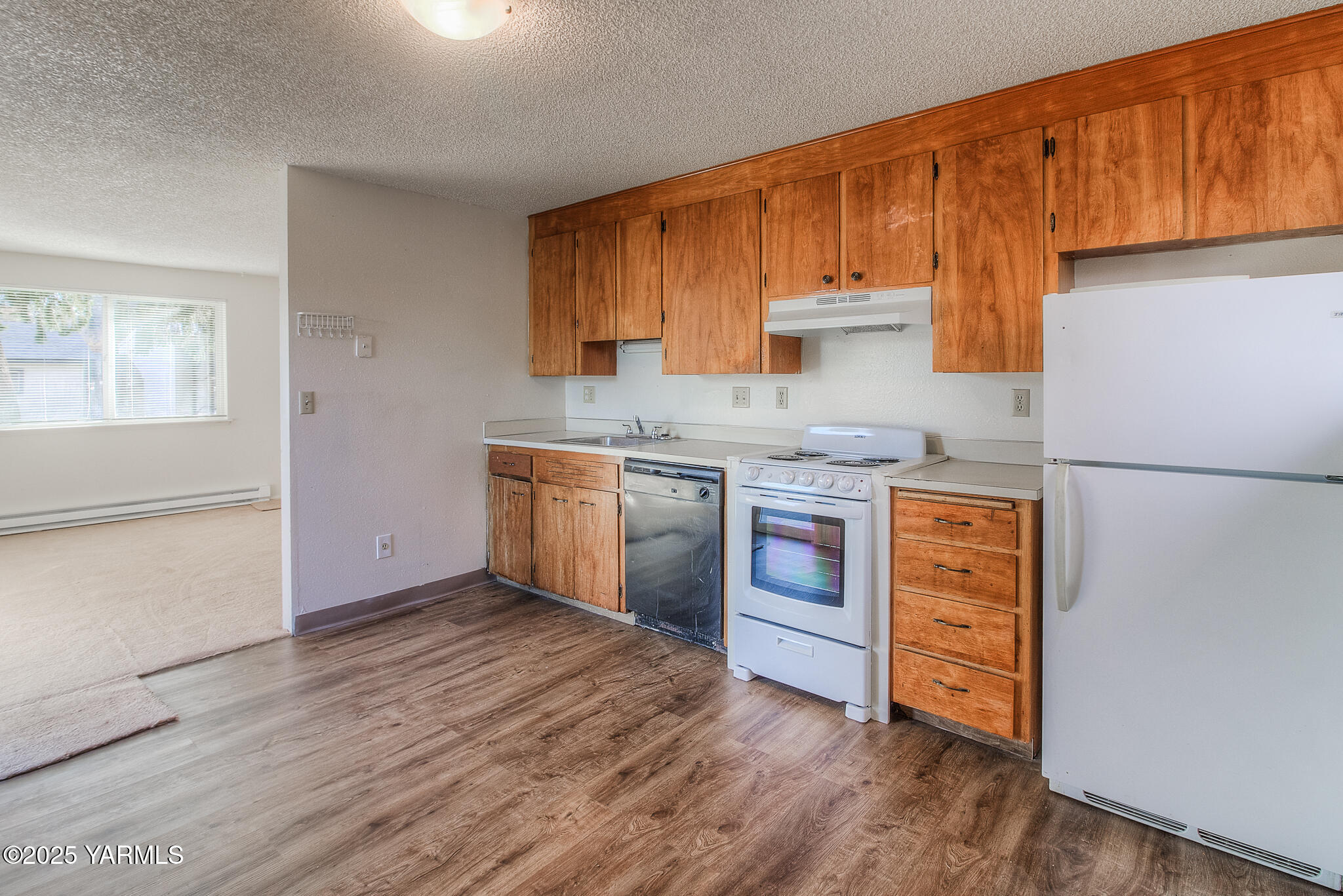 104 Moxee Avenue Naches, WA 98937 - Photo 5 of 22 a kitchen with stainless steel appliances granite countertop a stove a sink and a refrigerator with wooden floors