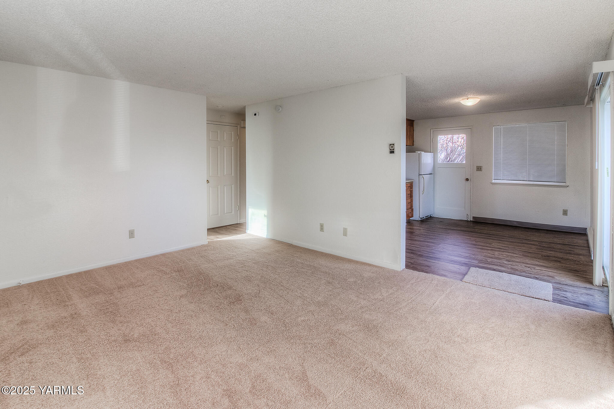 104 Moxee Avenue Naches, WA 98937 - Photo 7 of 22 a view of an empty room and kitchen and window