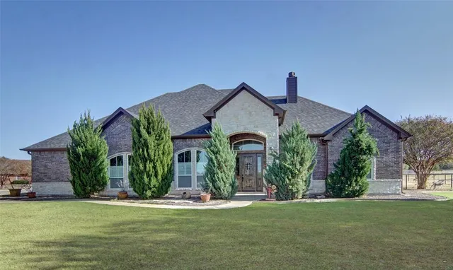 a front view of a house with garden