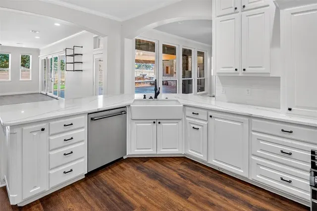 a view of a kitchen with sink and dishwasher stove with wooden floor