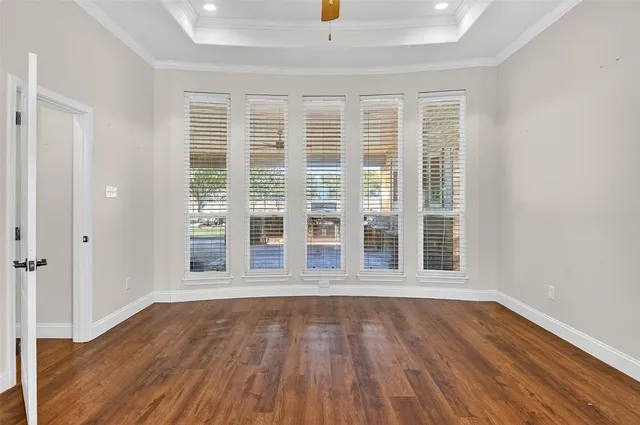 a view of wooden floor and a window in a room