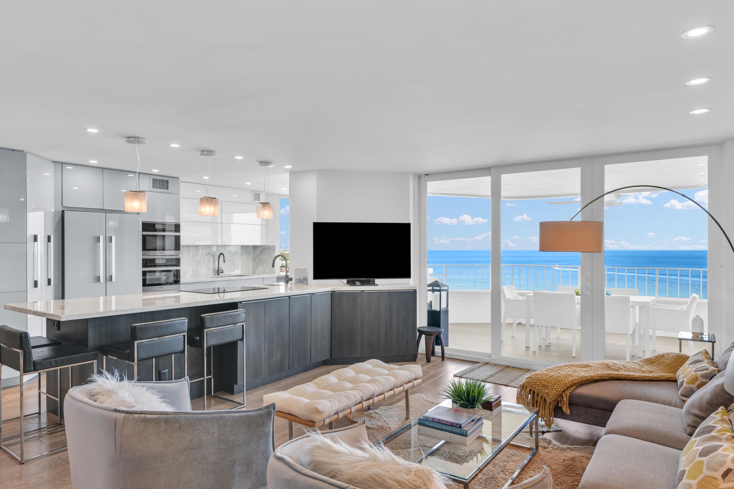 500 South Ocean Boulevard, Unit 1905 Boca Raton, FL 33432 - Photo 14 of 73 a living room with stainless steel appliances kitchen island granite countertop a couch and a flat screen tv
