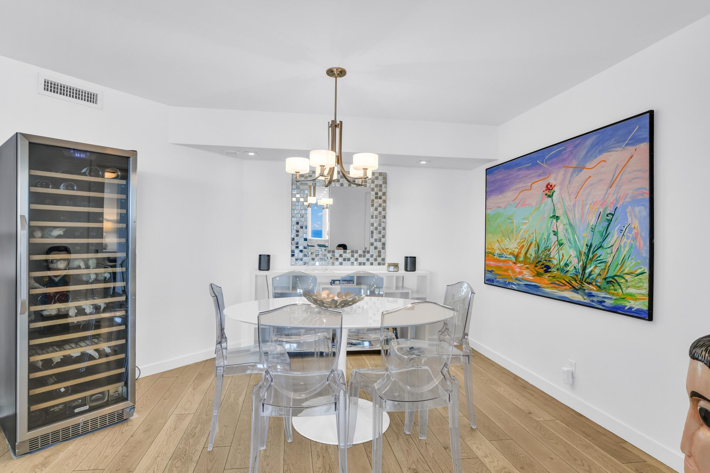 500 South Ocean Boulevard, Unit 1905 Boca Raton, FL 33432 - Photo 20 of 73 a view of a dining room with furniture wooden floor and a chandelier