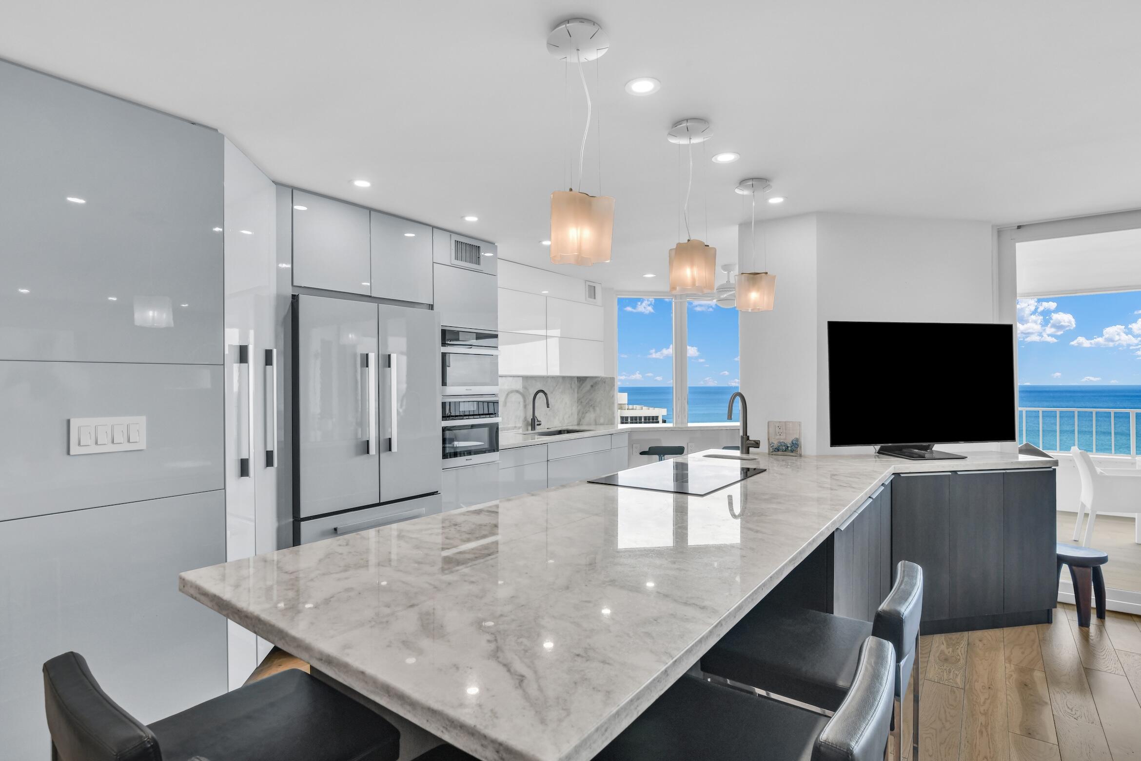 500 South Ocean Boulevard, Unit 1905 Boca Raton, FL 33432 - Photo 2 of 73 a large kitchen with a table and chairs