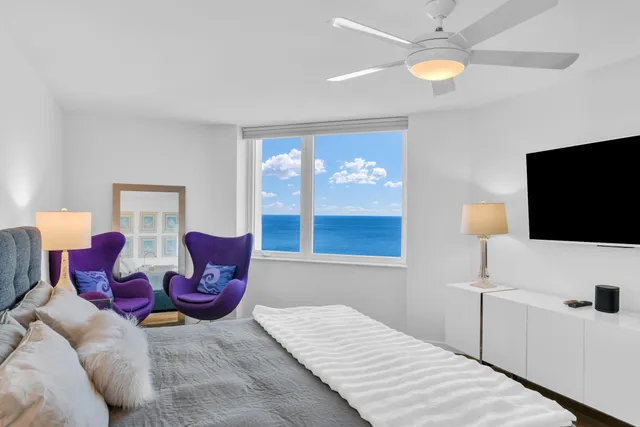 a bedroom with a large bed and a flat screen tv