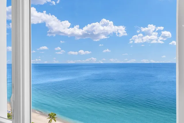a view of a dining room with furniture and a floor to ceiling window