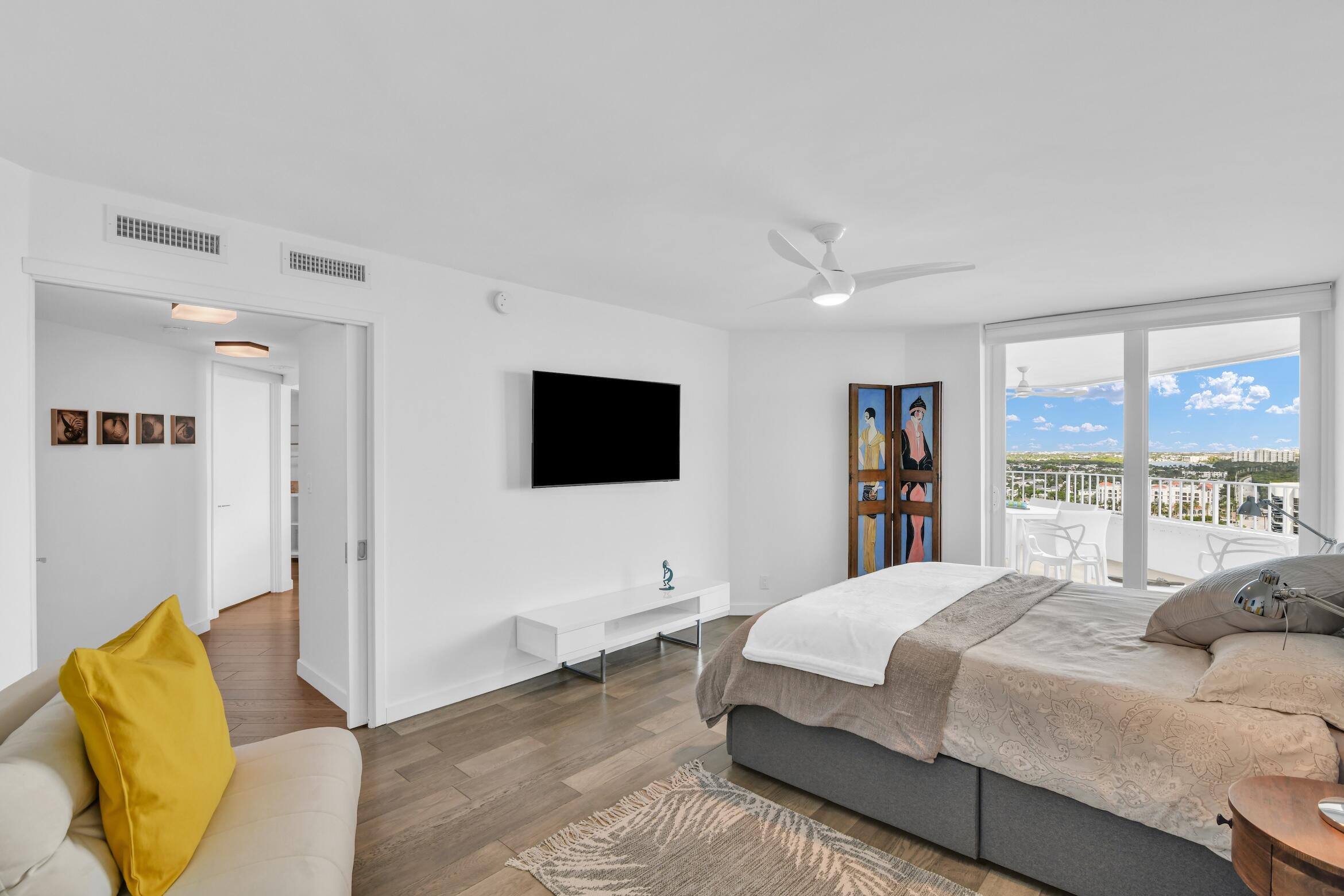 500 South Ocean Boulevard, Unit 1905 Boca Raton, FL 33432 - Photo 28 of 73 a bedroom with a large bed and a flat screen tv
