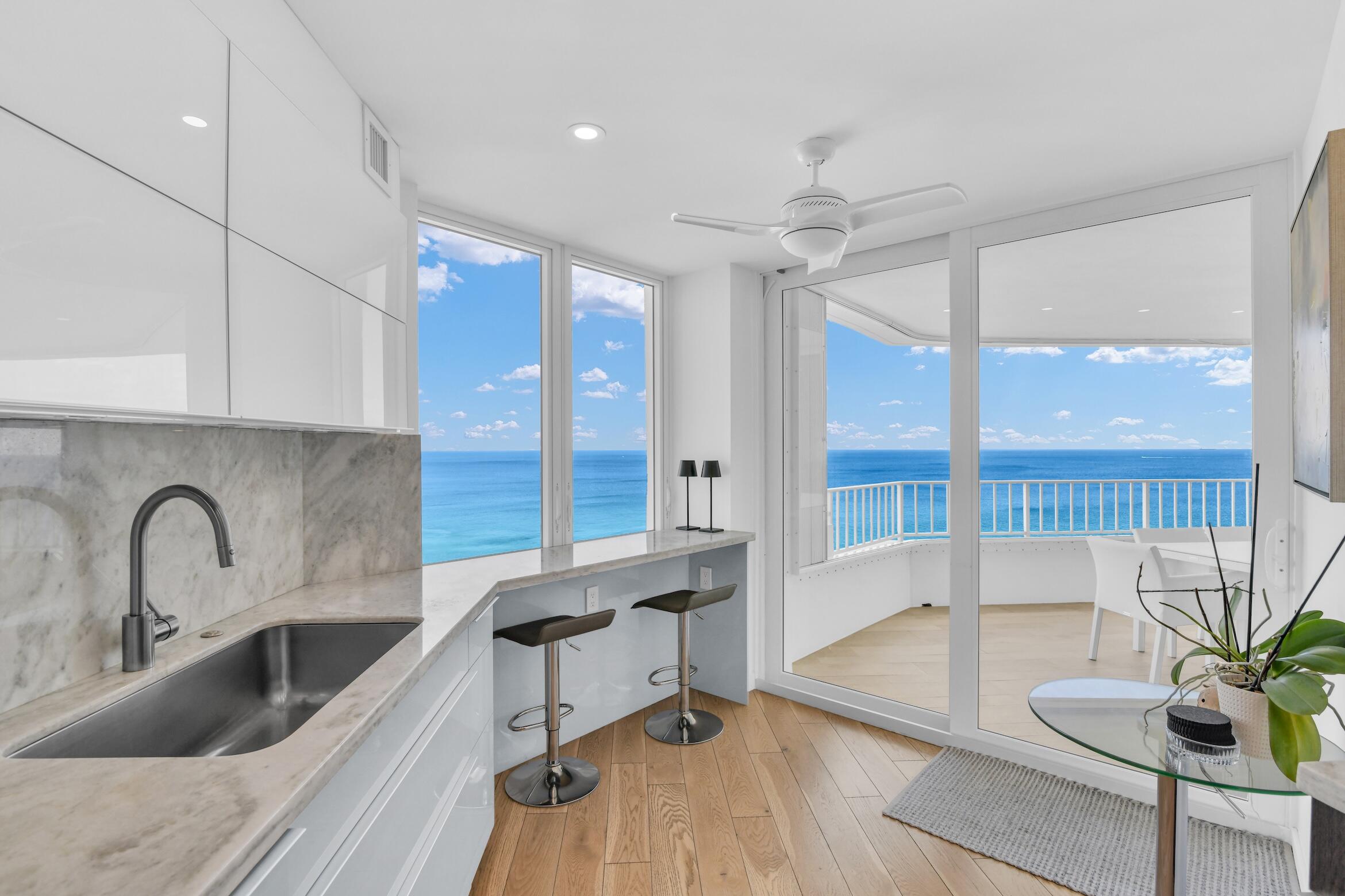 500 South Ocean Boulevard, Unit 1905 Boca Raton, FL 33432 - Photo 9 of 73 a kitchen with granite countertop a sink a counter top space and living room area