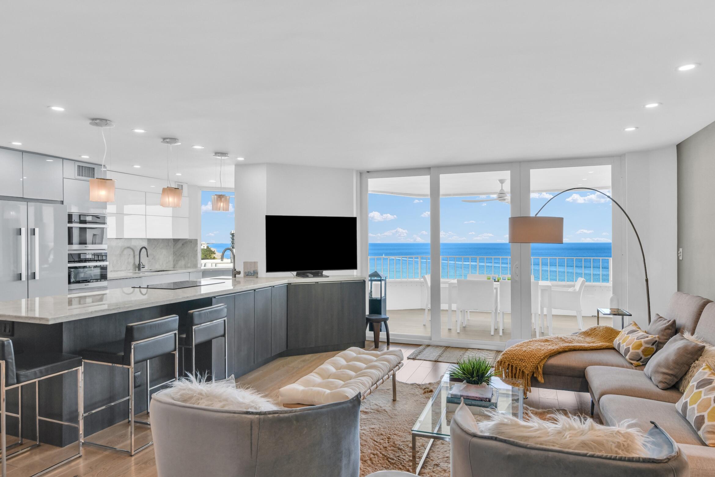 500 South Ocean Boulevard, Unit 1905 Boca Raton, FL 33432 - Photo 10 of 73 a living room with furniture a flat screen tv and a floor to ceiling window