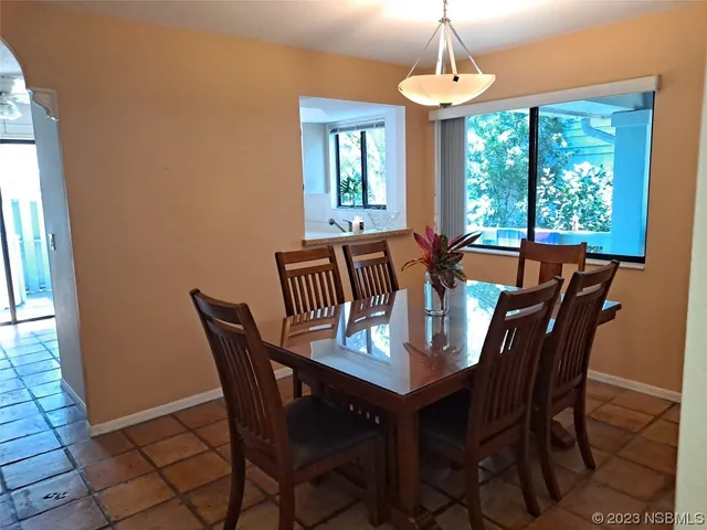 a view of a dining room with furniture window and outside view