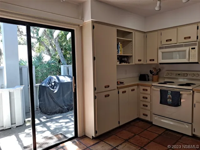 a kitchen with stainless steel appliances granite countertop a refrigerator and a stove
