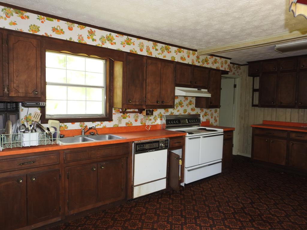 333 Lickskillet Road Epworth, GA 30541 - Photo 23 of 32 a kitchen with a sink stove and cabinets