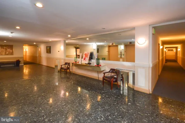 a lobby with furniture and a large mirror