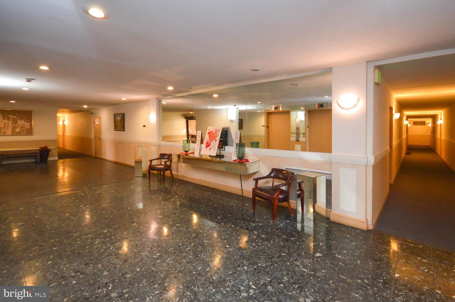 6317 Park Heights Avenue, Unit 310 Baltimore, MD 21215 - Photo 11 of 37 a lobby with furniture and a large mirror