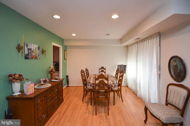 a dining room with furniture and wooden floor