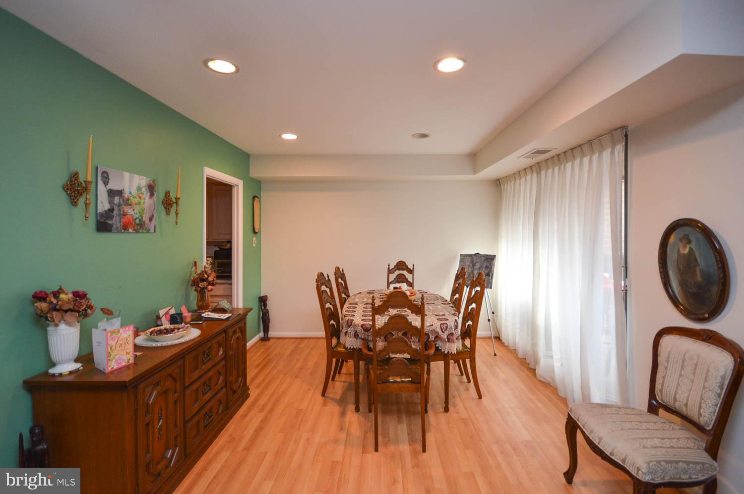 6317 Park Heights Avenue, Unit 310 Baltimore, MD 21215 - Photo 20 of 37 a dining room with furniture and wooden floor