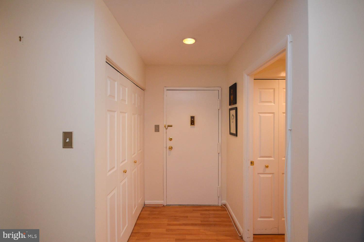 6317 Park Heights Avenue, Unit 310 Baltimore, MD 21215 - Photo 29 of 37 a view of a hallway with wooden floor and staircase