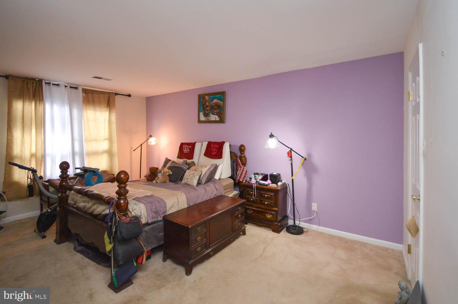 6317 Park Heights Avenue, Unit 310 Baltimore, MD 21215 - Photo 30 of 37 a bedroom with a bed and a chandelier