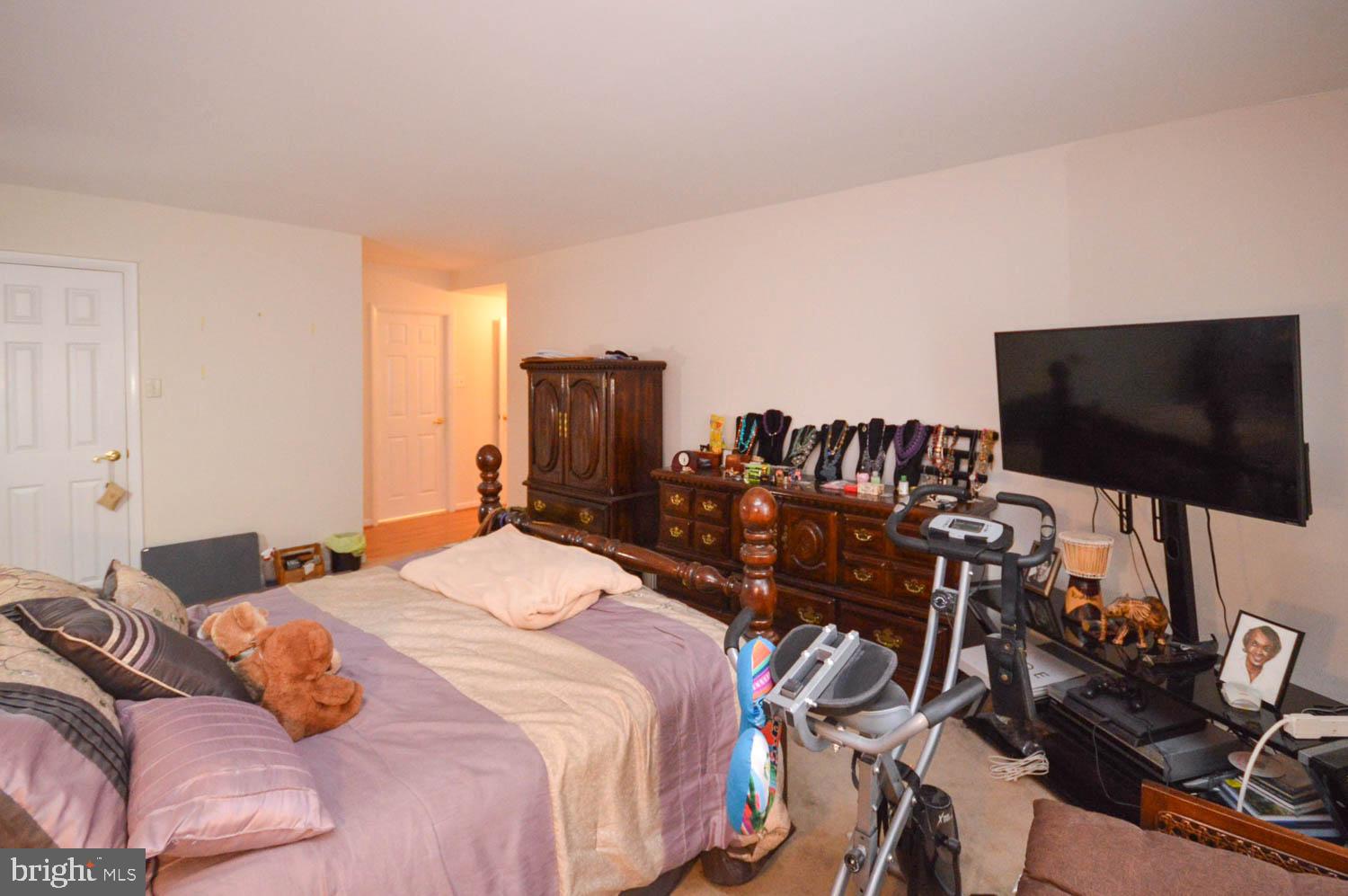 6317 Park Heights Avenue, Unit 310 Baltimore, MD 21215 - Photo 31 of 37 a bedroom with a bed and a flat screen tv