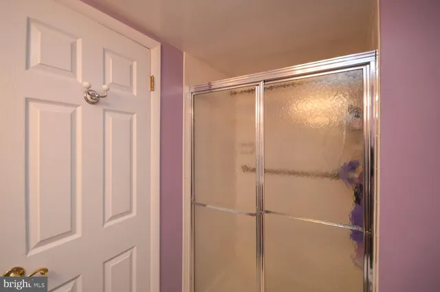 a bathroom with a glass shower door