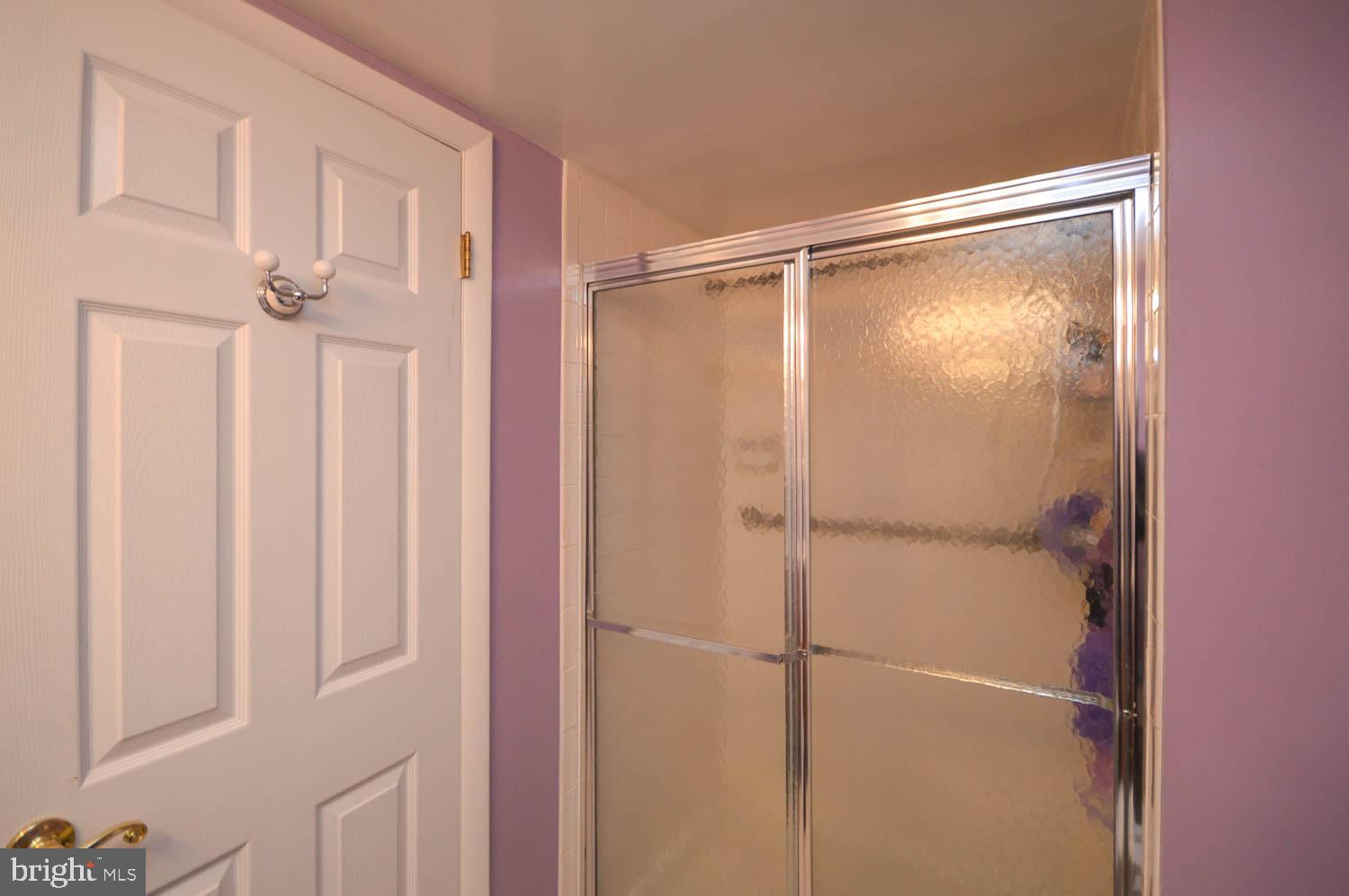 6317 Park Heights Avenue, Unit 310 Baltimore, MD 21215 - Photo 34 of 37 a bathroom with a glass shower door