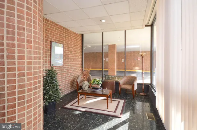 a living room with furniture and a floor to ceiling window