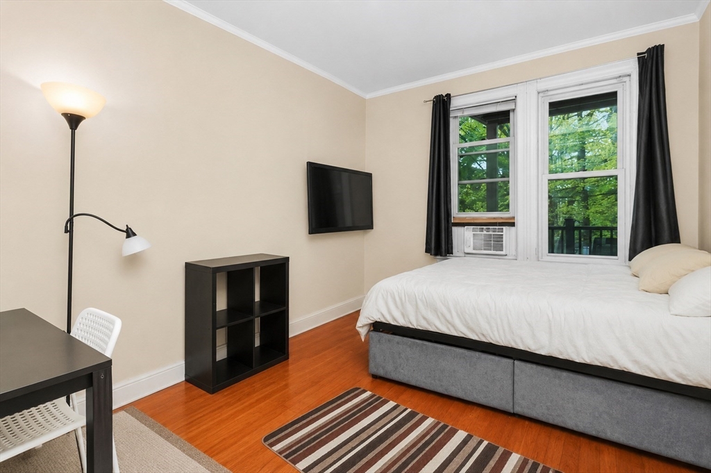 8 Colliston Road Boston, MA 02135 - Photo 19 of 40 a bed room with a bed tv and a window