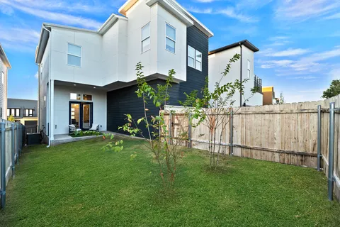 a view of a house with a swimming pool and a yard