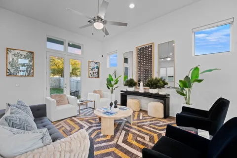 a living room with furniture flowers and a chandelier