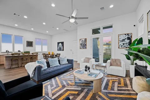 a living room with furniture kitchen and a table
