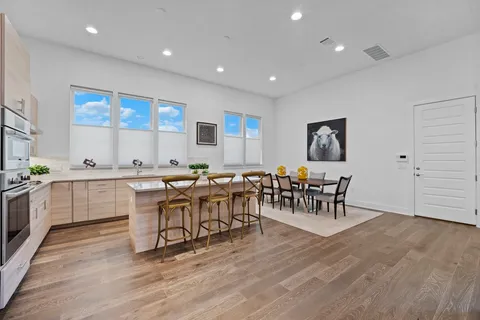 a living room with furniture a dining table and chairs