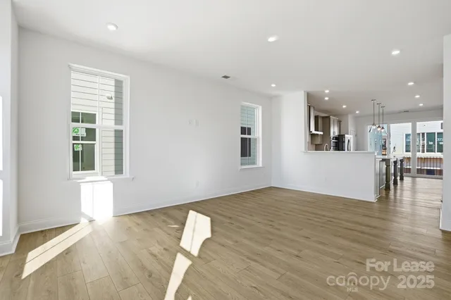 a kitchen with stainless steel appliances granite countertop a sink a stove and a wooden floors