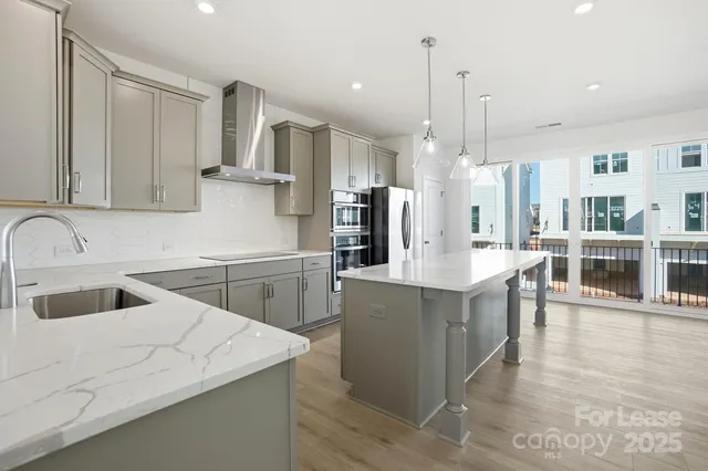 a large white kitchen with a large window