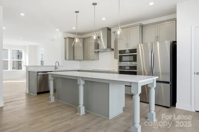a kitchen with a sink a counter top space and appliances