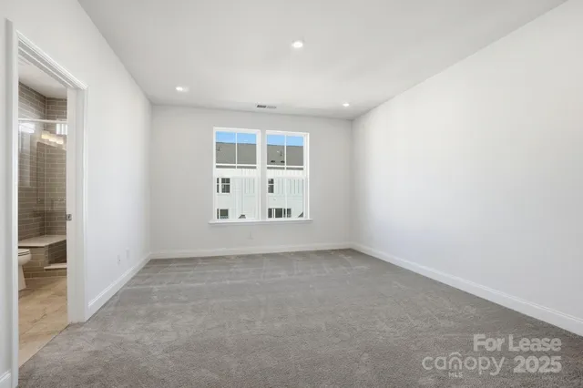 an empty room with a cabinet and mirrors