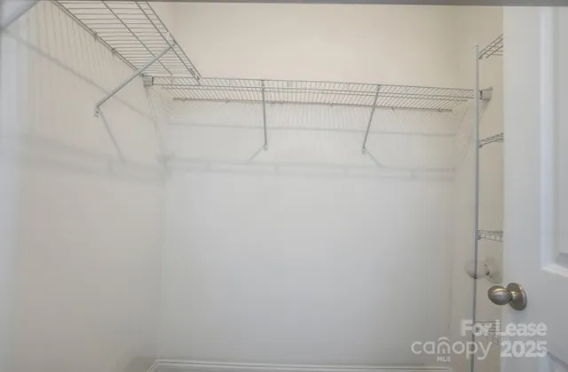 a view of an empty room with a kitchen