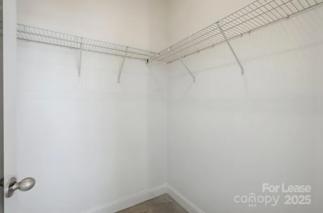a spacious bathroom with a shower toilet sink and mirror