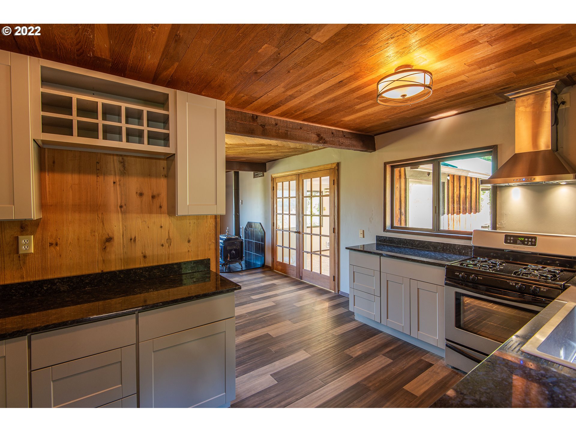 66001 Sunshine Road Coos Bay, OR 97420 - Photo 12 of 32 a kitchen with wooden cabinets and a stove top oven