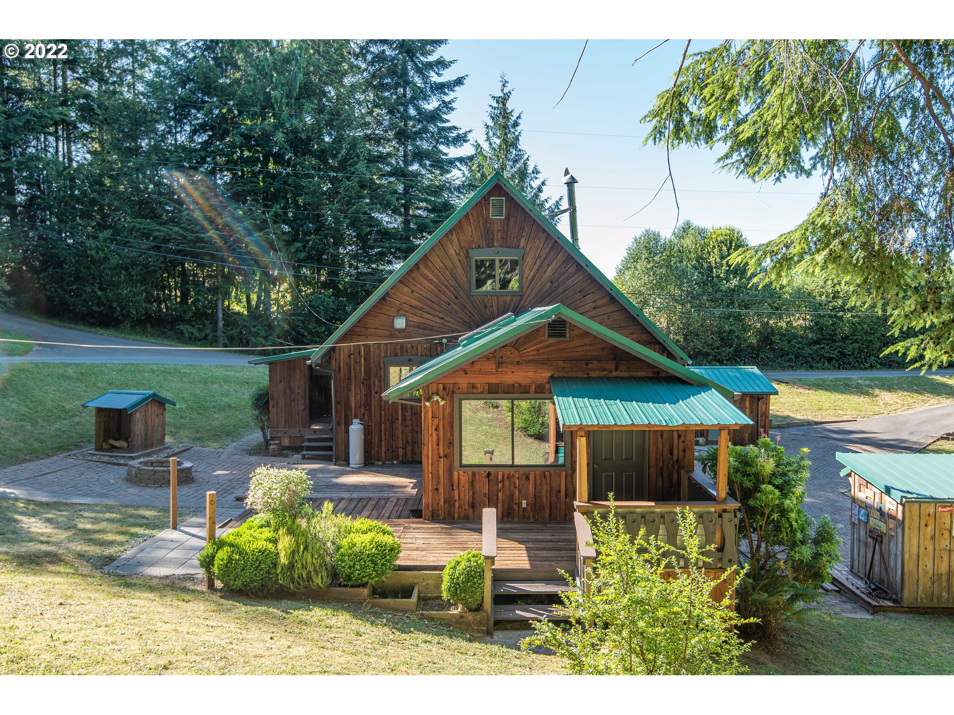 66001 Sunshine Road Coos Bay, OR 97420 - Photo 23 of 32 a backyard of a house with table and chairs