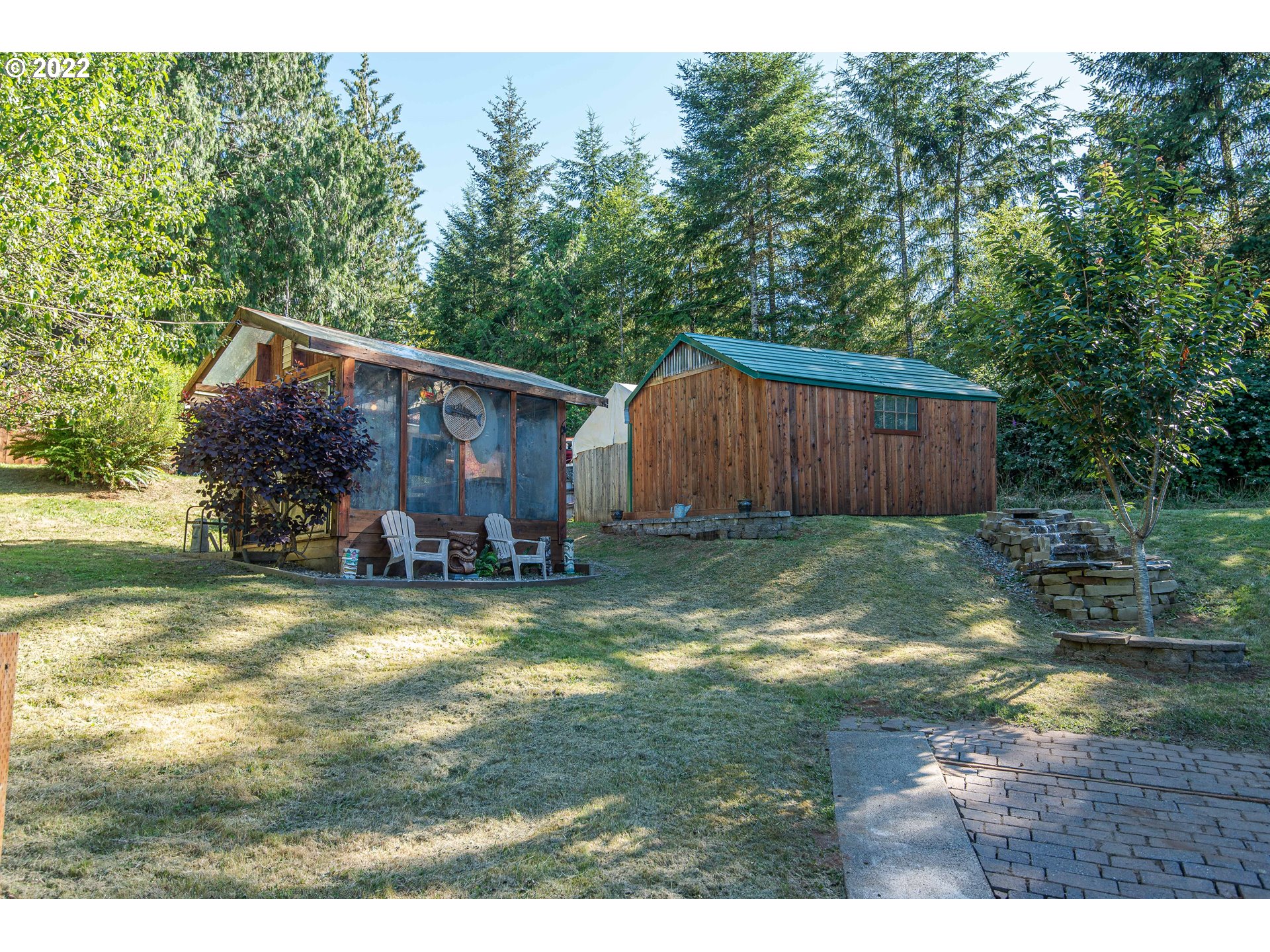 66001 Sunshine Road Coos Bay, OR 97420 - Photo 24 of 32 a view of a house with backyard and sitting area