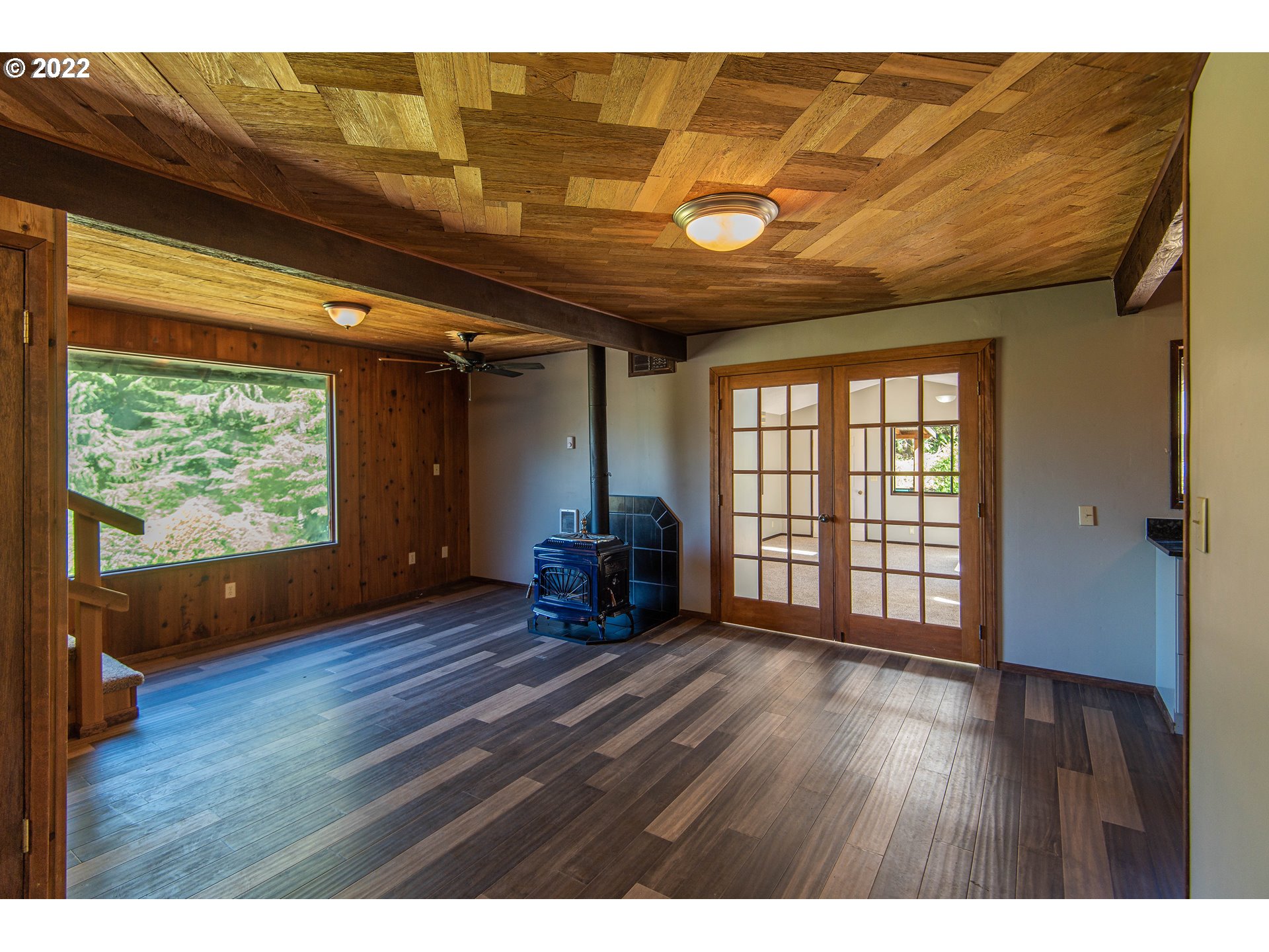 66001 Sunshine Road Coos Bay, OR 97420 - Photo 6 of 32 a view of an empty room with wooden floor and a window