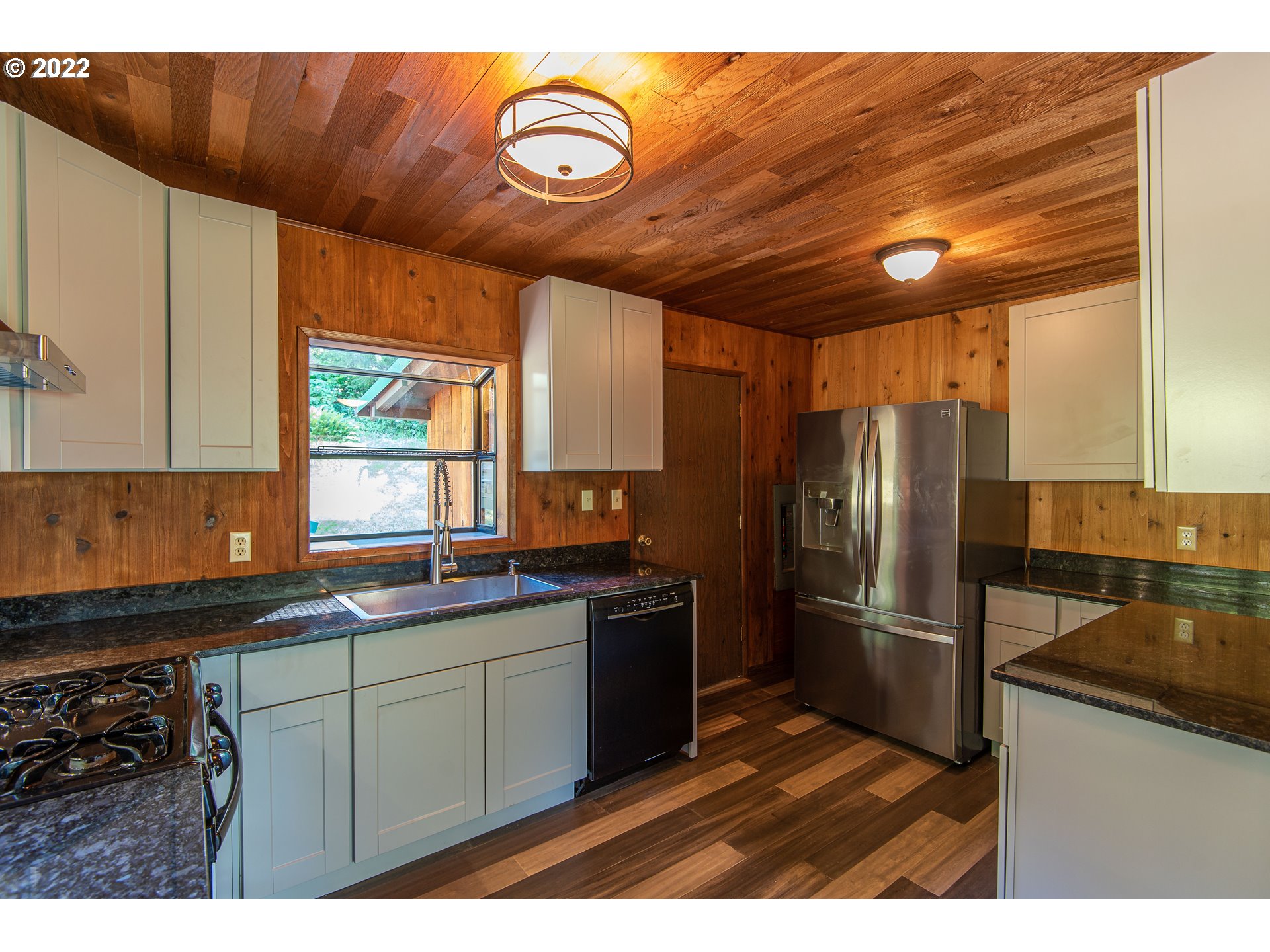 66001 Sunshine Road Coos Bay, OR 97420 - Photo 9 of 32 a kitchen with stainless steel appliances granite countertop a sink a stove and refrigerator