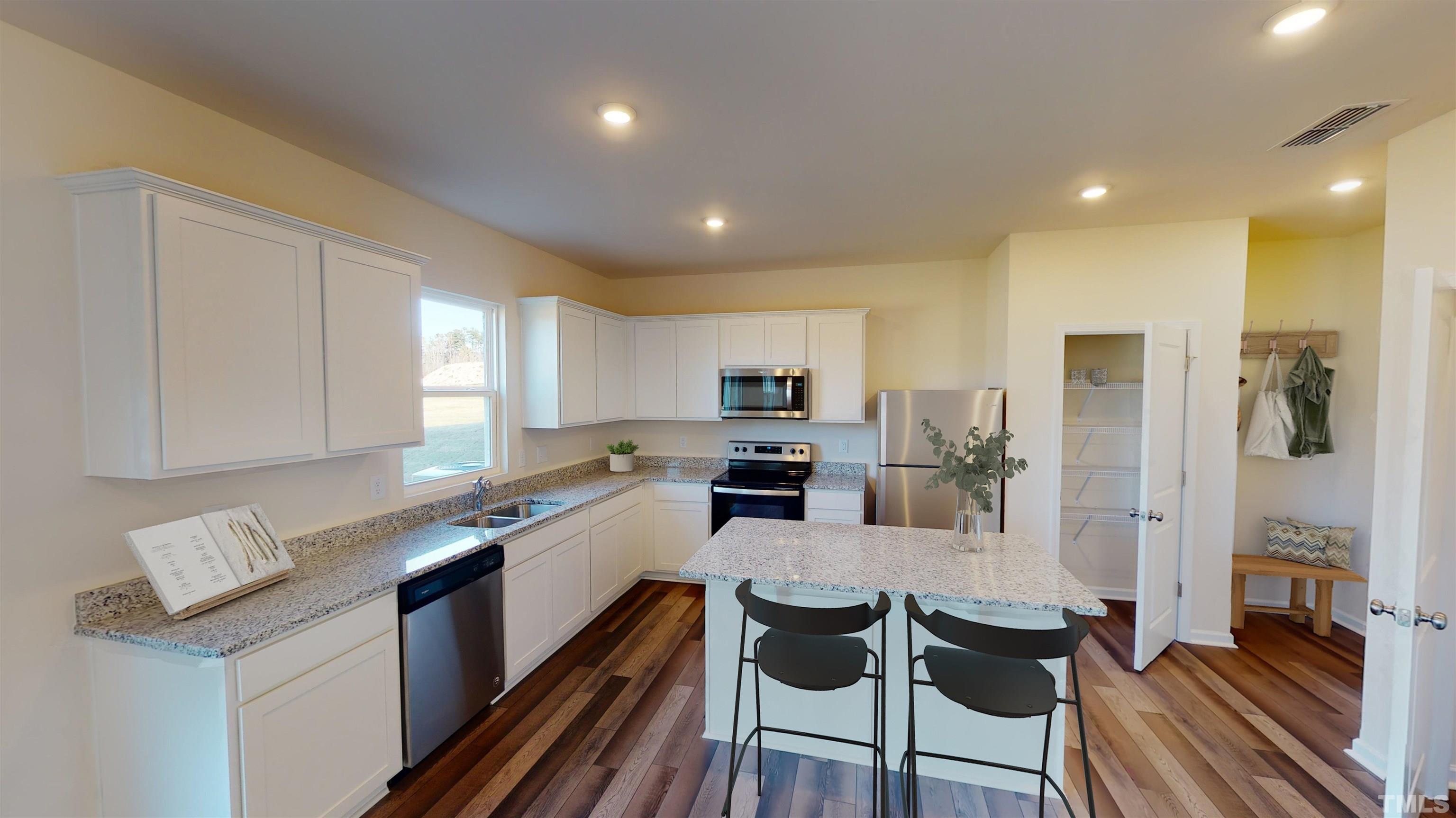 3473 Dragonfly River Court Raleigh, NC 27604 - Photo 11 of 26 a kitchen with granite countertop a sink and cabinets