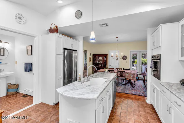 a large kitchen with cabinets table and chairs