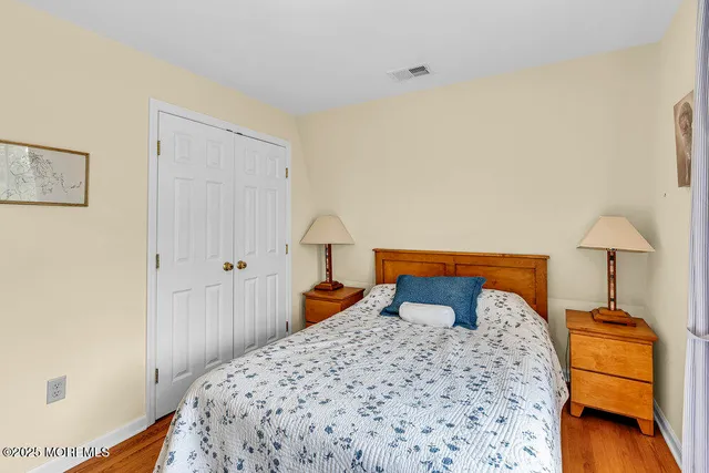 a bedroom with a bed and a lamp