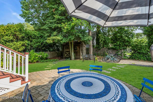 a view of a backyard with swimming pool garden and patio