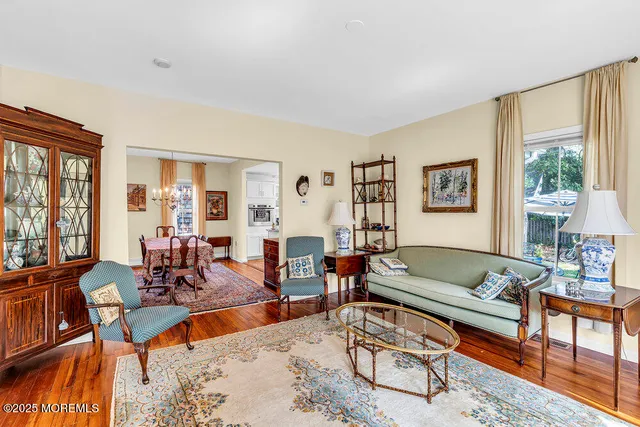 a living room with furniture a wooden floor and a large window