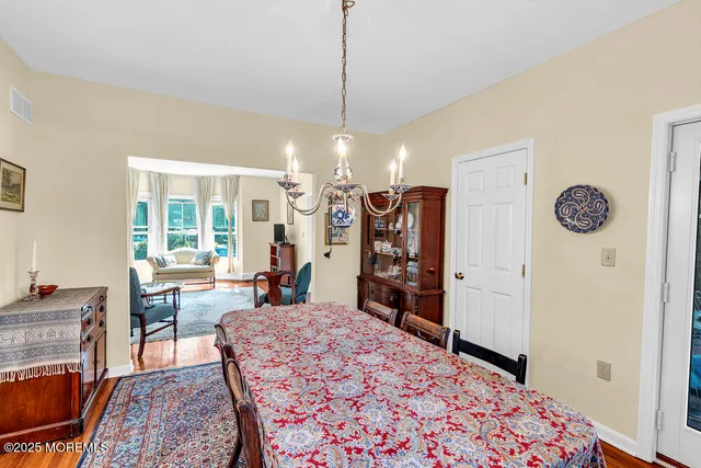a living room with a large bed and a chandelier